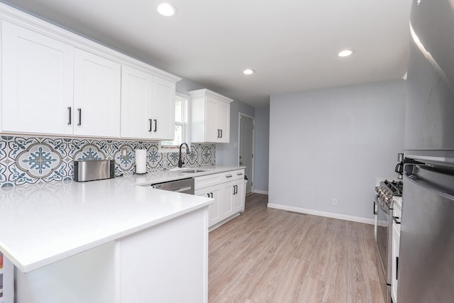 620 Edwin Dr, Bourbonnais, IL 60914 - kitchen featuring light countertops, decorative backsplash, a peninsula, white cabinets, and recessed lighting