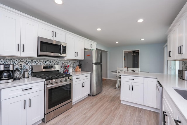 620 Edwin Dr, Bourbonnais, IL 60914 - kitchen featuring appliances with stainless steel finishes, a peninsula, light countertops, recessed lighting, and backsplash