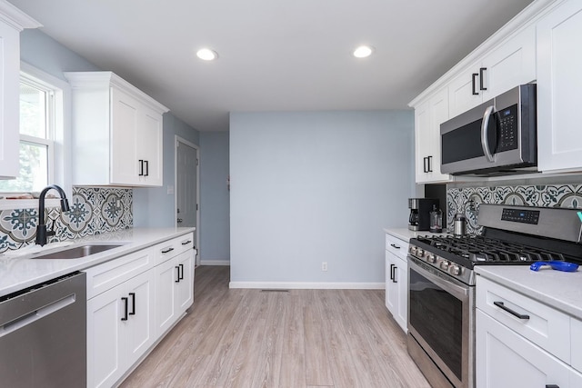 620 Edwin Dr, Bourbonnais, IL 60914 - kitchen with stainless steel appliances, decorative backsplash, recessed lighting, light countertops, and white cabinetry
