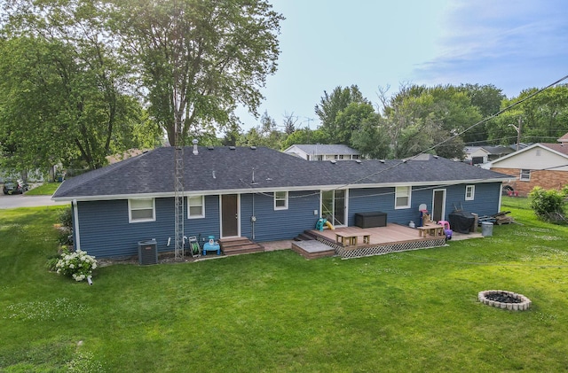 620 Edwin Dr, Bourbonnais, IL 60914 - rear view of house featuring a wooden deck, a fire pit, a lawn, and roof with shingles