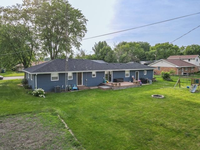 620 Edwin Dr, Bourbonnais, IL 60914 - back of property with a fire pit, a wooden deck, a lawn, and a playground