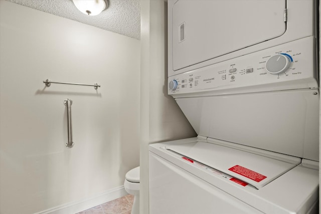 920 Vose Dr Unit 612, Gurnee, IL 60031 - laundry area featuring a textured ceiling, stacked washer / dryer, and tile patterned floors