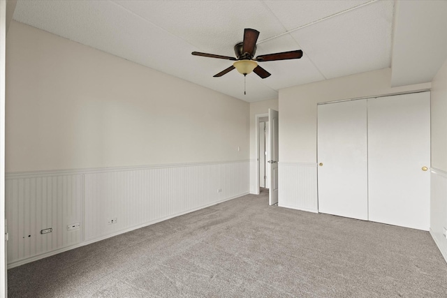 920 Vose Dr Unit 612, Gurnee, IL 60031 - unfurnished bedroom featuring wainscoting, carpet flooring, a closet, and ceiling fan