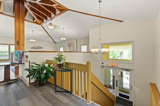 920 Vose Dr Unit 612, Gurnee, IL 60031 - corridor featuring a chandelier, wood finished floors, an upstairs landing, and vaulted ceiling