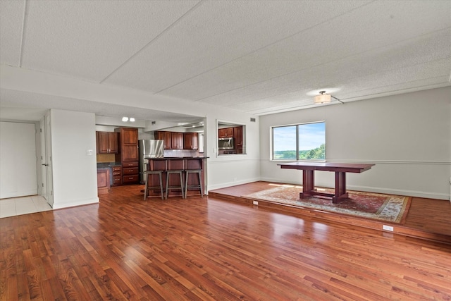 920 Vose Dr Unit 612, Gurnee, IL 60031 - unfurnished living room with dark wood-type flooring and a textured ceiling