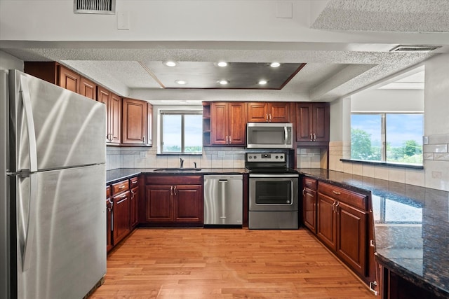 920 Vose Dr Unit 612, Gurnee, IL 60031 - kitchen featuring appliances with stainless steel finishes, plenty of natural light, light wood-type flooring, a tray ceiling, and recessed lighting