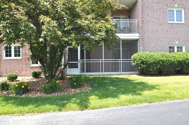 11535 Settlers Pond Way Unit 1C, Orland Park, IL 60467 - view of side of property with brick siding, a yard, and a balcony