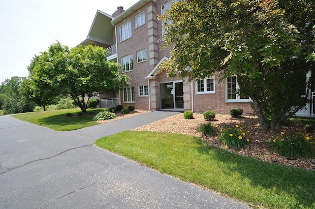 11535 Settlers Pond Way Unit 1C, Orland Park, IL 60467 - view of front facade with brick siding and a front lawn