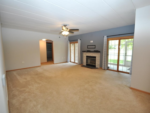11535 Settlers Pond Way Unit 1C, Orland Park, IL 60467 - unfurnished living room featuring light carpet, a fireplace, a ceiling fan, and arched walkways