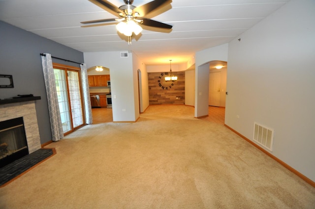 11535 Settlers Pond Way Unit 1C, Orland Park, IL 60467 - unfurnished living room featuring arched walkways, a fireplace, light colored carpet, ceiling fan, and a chandelier