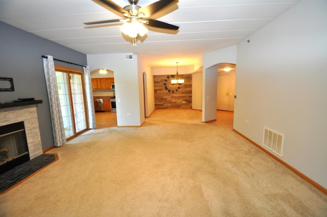 11535 Settlers Pond Way Unit 1C, Orland Park, IL 60467 - unfurnished living room with arched walkways, a stone fireplace, light colored carpet, ceiling fan, and a chandelier