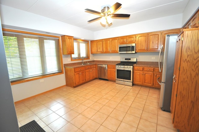 11535 Settlers Pond Way Unit 1C, Orland Park, IL 60467 - kitchen with stainless steel appliances, brown cabinetry, and ceiling fan