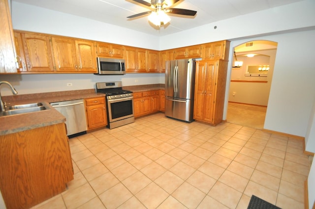 11535 Settlers Pond Way Unit 1C, Orland Park, IL 60467 - kitchen with appliances with stainless steel finishes, a ceiling fan, brown cabinets, and arched walkways