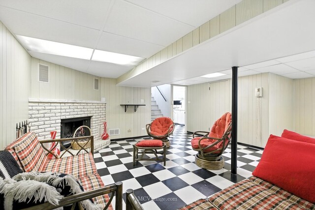 3219 N Pioneer Ave, Chicago, IL 60634 - living area featuring tile patterned floors, stairs, a brick fireplace, a paneled ceiling, and wooden walls