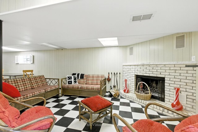 3219 N Pioneer Ave, Chicago, IL 60634 - living room with tile patterned floors, a brick fireplace, a wall unit AC, and wooden walls