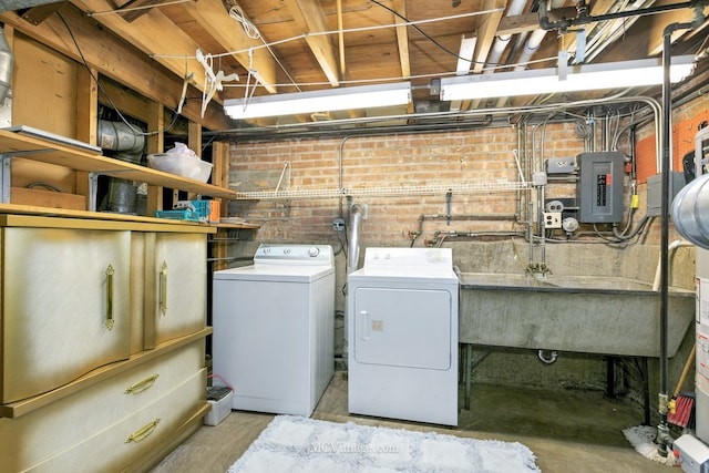 3219 N Pioneer Ave, Chicago, IL 60634 - laundry room featuring electric panel, separate washer and dryer, and brick wall