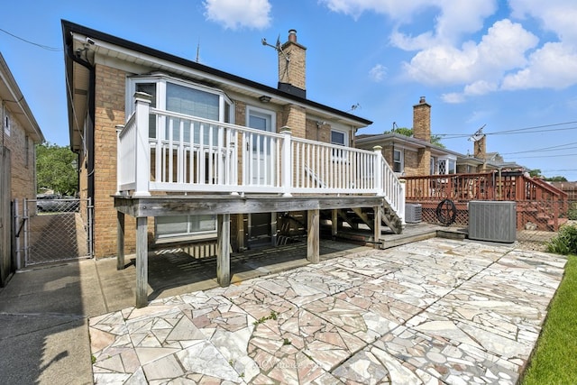 3219 N Pioneer Ave, Chicago, IL 60634 - rear view of property with a patio, a deck, stairs, brick siding, and a gate