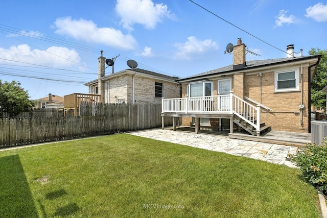 3219 N Pioneer Ave, Chicago, IL 60634 - back of property with brick siding, a chimney, a patio area, and a wooden deck