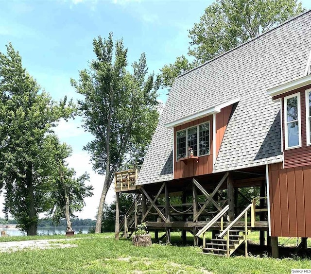 110 E County Rd 150, Warsaw, IL 62379 - rear view of house with a shingled roof, board and batten siding, stairs, and a water view