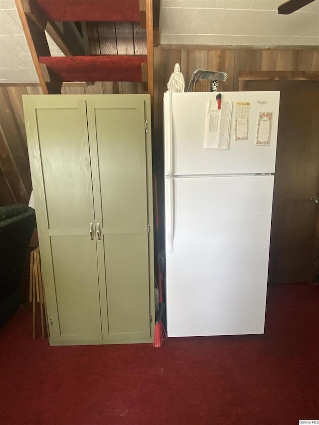 110 E County Rd 150, Warsaw, IL 62379 - kitchen with freestanding refrigerator, carpet flooring, wood walls, and ceiling fan