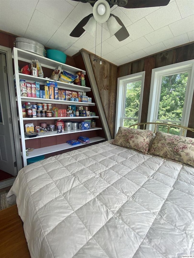 110 E County Rd 150, Warsaw, IL 62379 - bedroom featuring wood walls and a ceiling fan