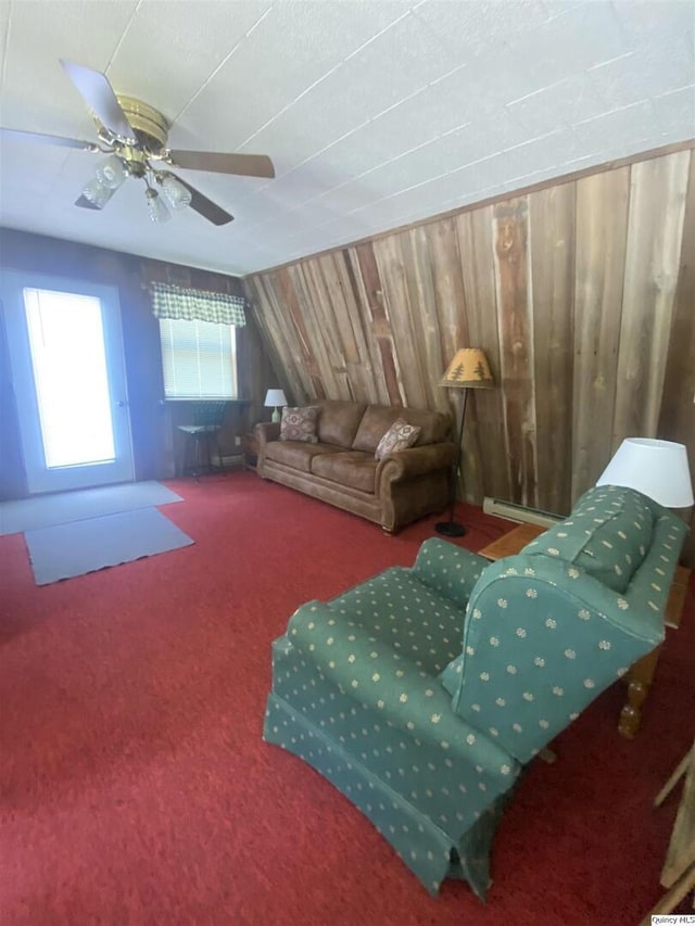 110 E County Rd 150, Warsaw, IL 62379 - carpeted living area featuring ceiling fan, lofted ceiling, wood walls, and a baseboard heating unit