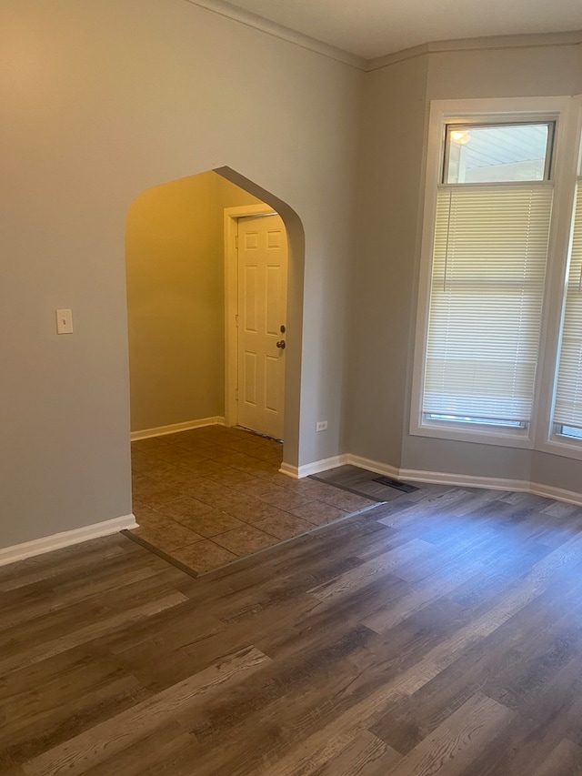 537 W 61st Pl, Chicago, IL 60621 - spare room with arched walkways, wood finished floors, crown molding, and healthy amount of natural light