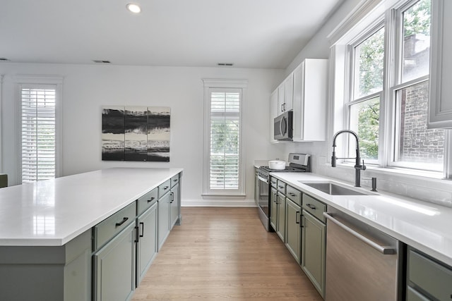 1501 W Diversey Pkwy Unit B, Chicago, IL 60614 - kitchen featuring appliances with stainless steel finishes, gray cabinets, light wood-type flooring, light countertops, and recessed lighting