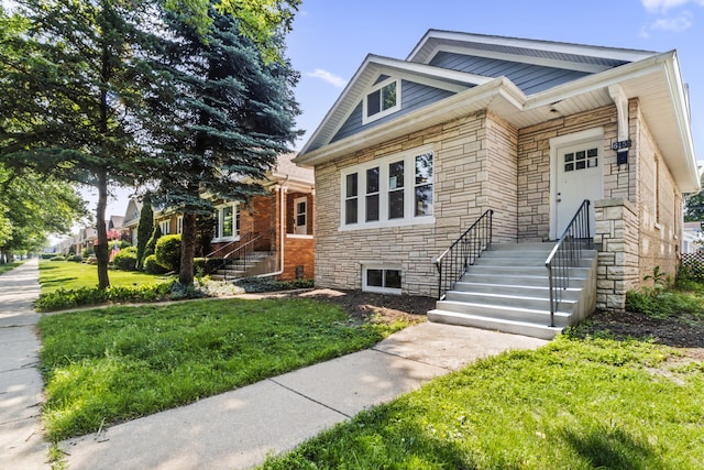 6155 W Cornelia Ave, Chicago, IL 60634 - bungalow-style home with stone siding and a front lawn