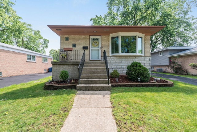 14437 Kostner Ave, Midlothian, IL 60445 - view of front of property with a front yard, a porch, brick siding, and stone siding