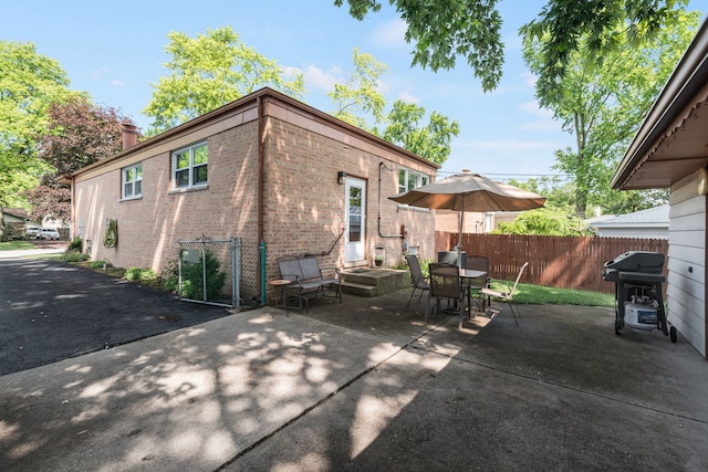 14437 Kostner Ave, Midlothian, IL 60445 - rear view of house featuring brick siding, a chimney, a patio, and outdoor dining space