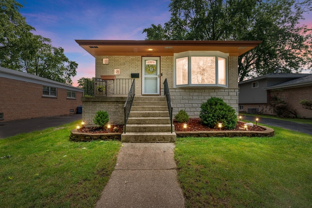 14437 Kostner Ave, Midlothian, IL 60445 - view of front facade featuring covered porch, a front yard, and brick siding