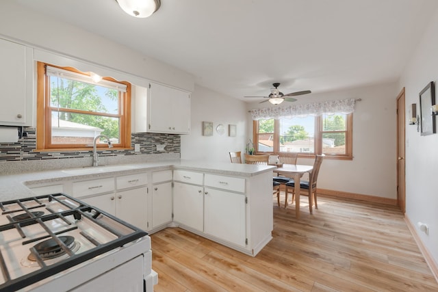 14437 Kostner Ave, Midlothian, IL 60445 - kitchen with white gas range oven, ceiling fan, backsplash, and light countertops
