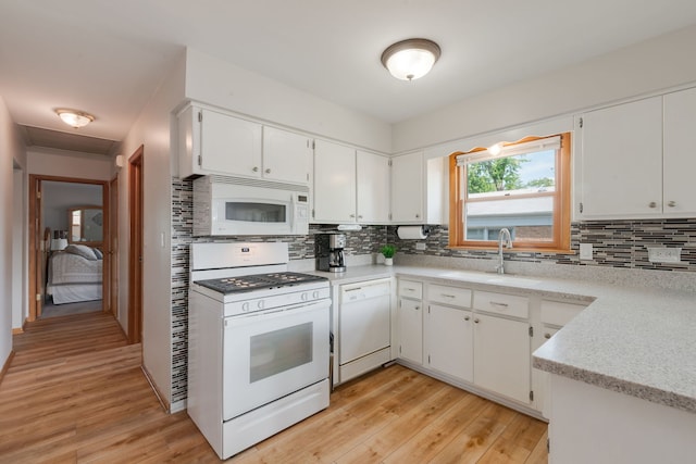 14437 Kostner Ave, Midlothian, IL 60445 - kitchen featuring white appliances, tasteful backsplash, light wood finished floors, and white cabinets