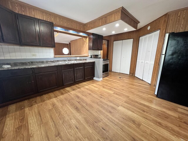 327 Somonauk St, Park Forest, IL 60466 - kitchen with freestanding refrigerator, gas stove, light wood-type flooring, backsplash, and dark brown cabinets