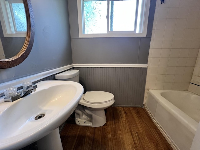 327 Somonauk St, Park Forest, IL 60466 - bathroom featuring a wainscoted wall, a bathtub, and wood finished floors