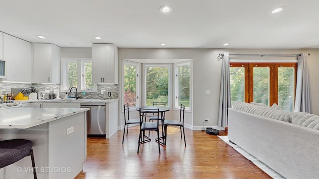 3425 Woodlawn Ave, Gurnee, IL 60031 - kitchen with dishwasher, recessed lighting, tasteful backsplash, white cabinetry, and light wood finished floors