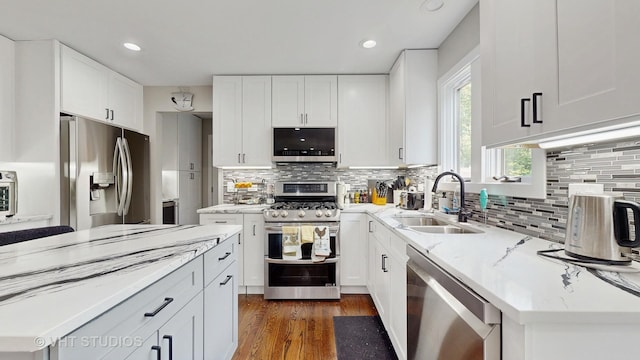3425 Woodlawn Ave, Gurnee, IL 60031 - kitchen with appliances with stainless steel finishes, tasteful backsplash, light stone countertops, white cabinets, and recessed lighting