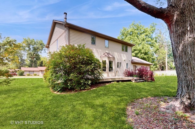 3425 Woodlawn Ave, Gurnee, IL 60031 - rear view of house featuring a wooden deck and a yard