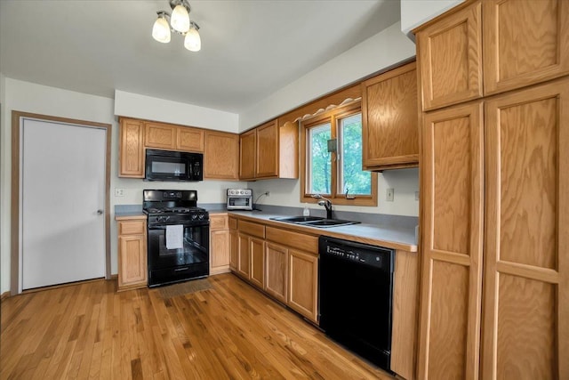 1801 Great Falls Dr, Plainfield, IL 60586 - kitchen featuring black appliances, light wood-style flooring, light countertops, and brown cabinets