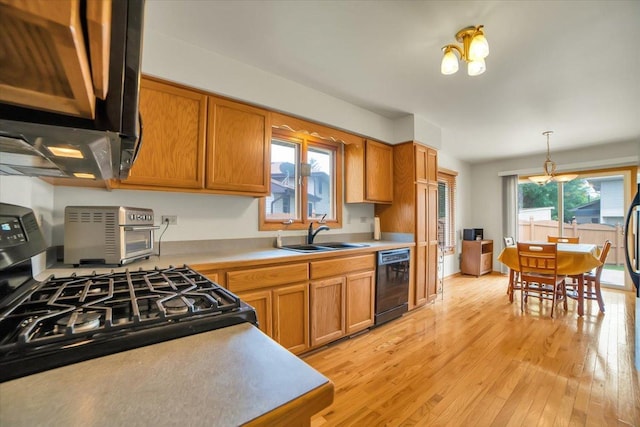 1801 Great Falls Dr, Plainfield, IL 60586 - kitchen featuring appliances with stainless steel finishes, light wood finished floors, light countertops, brown cabinetry, and a chandelier