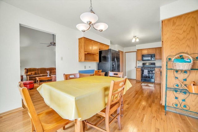 1801 Great Falls Dr, Plainfield, IL 60586 - dining space with light wood-style flooring, a chandelier, and a ceiling fan