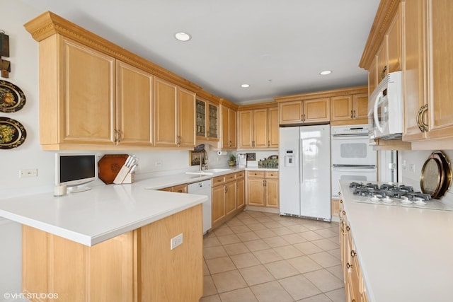 820 Weidner Rd Unit 409, Buffalo Grove, IL 60089 - kitchen featuring white appliances, a peninsula, light countertops, light tile patterned floors, and glass insert cabinets
