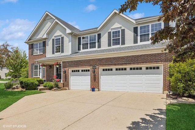 4345 Gladstone Dr, Lake In The Hills, IL 60156 - traditional-style house with driveway, a garage, and brick siding