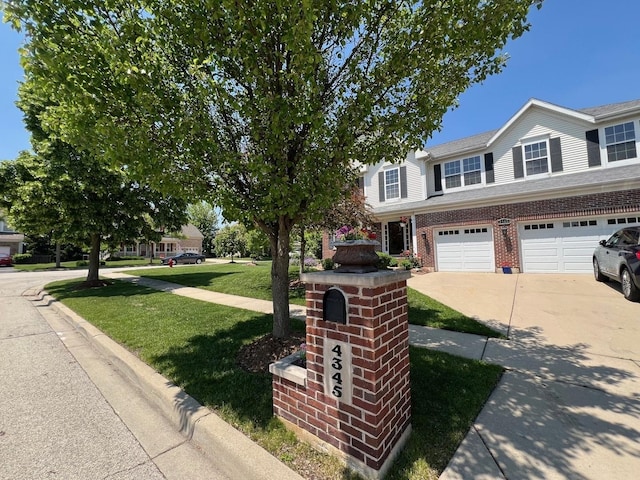 4345 Gladstone Dr, Lake In The Hills, IL 60156 - view of front of home featuring concrete driveway, a front yard, a garage, and brick siding
