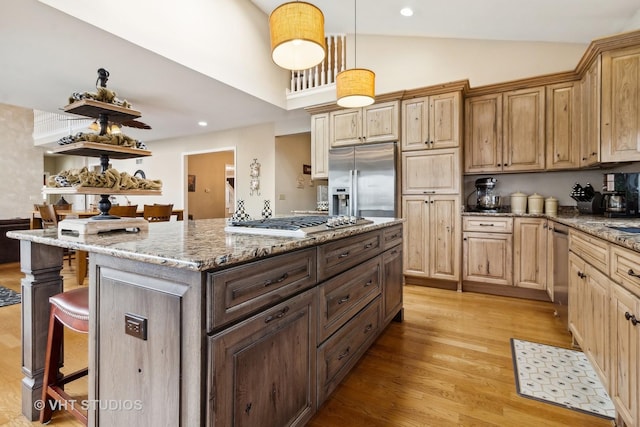 49W695 Hinckley Rd, Big Rock, IL 60511 - kitchen featuring stainless steel appliances, a breakfast bar, light wood-style floors, a kitchen island, and light stone counters