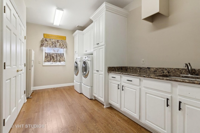 49W695 Hinckley Rd, Big Rock, IL 60511 - washroom with washer and dryer, cabinet space, and light wood-style flooring