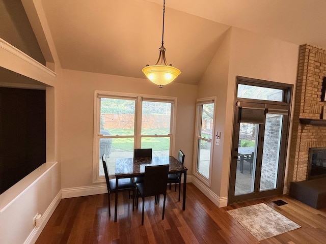 1779 Frost Ln, Naperville, IL 60564 - dining space featuring plenty of natural light, dark wood-style flooring, a brick fireplace, and high vaulted ceiling