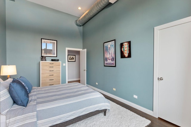 2411 W Walton St Unit 2B, Chicago, IL 60622 - bedroom with dark wood-style flooring, recessed lighting, and a towering ceiling
