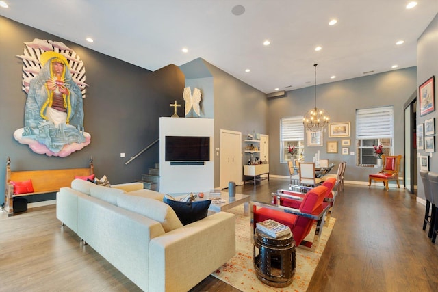2411 W Walton St Unit 2B, Chicago, IL 60622 - living room featuring wood finished floors, stairs, a chandelier, recessed lighting, and a towering ceiling